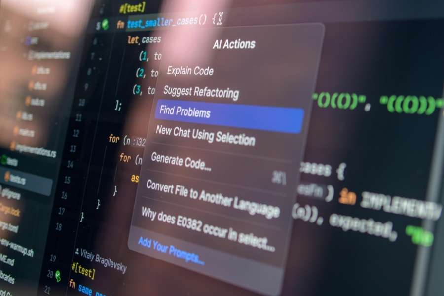 A computer monitor displaying lines of code with an open AI Actions context menu highlighting optimization options.